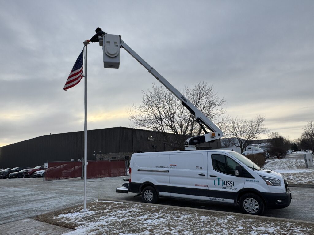 Versalift bucket truck setting a us flag