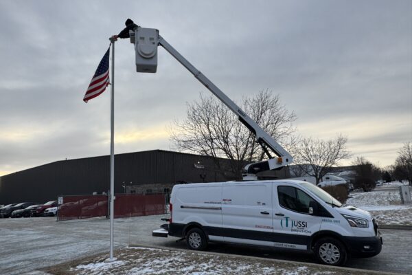 Versalift bucket truck setting a us flag