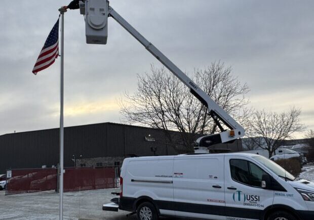 Versalift bucket truck setting a us flag